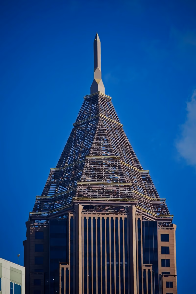 Looking up at the spire of an Atlanta skyscraper against a clear sky